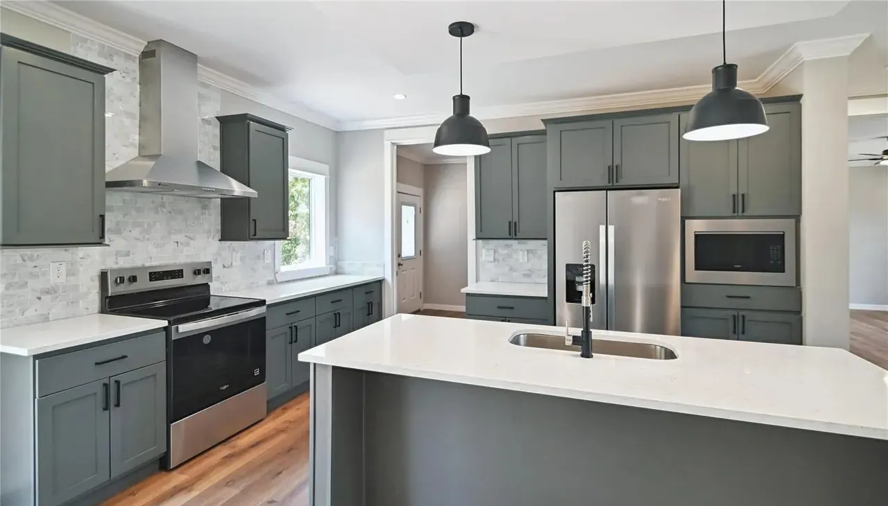 Kitchen range, tile backsplash and cabinets in a Hart Homes new home